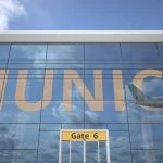Munich city name and landing plane at modern airport 3D rendering