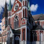 Red-White Coloured Sofia Cathedral In Jonkoping On A Sunny Summer Day With Some Clouds In The Sky