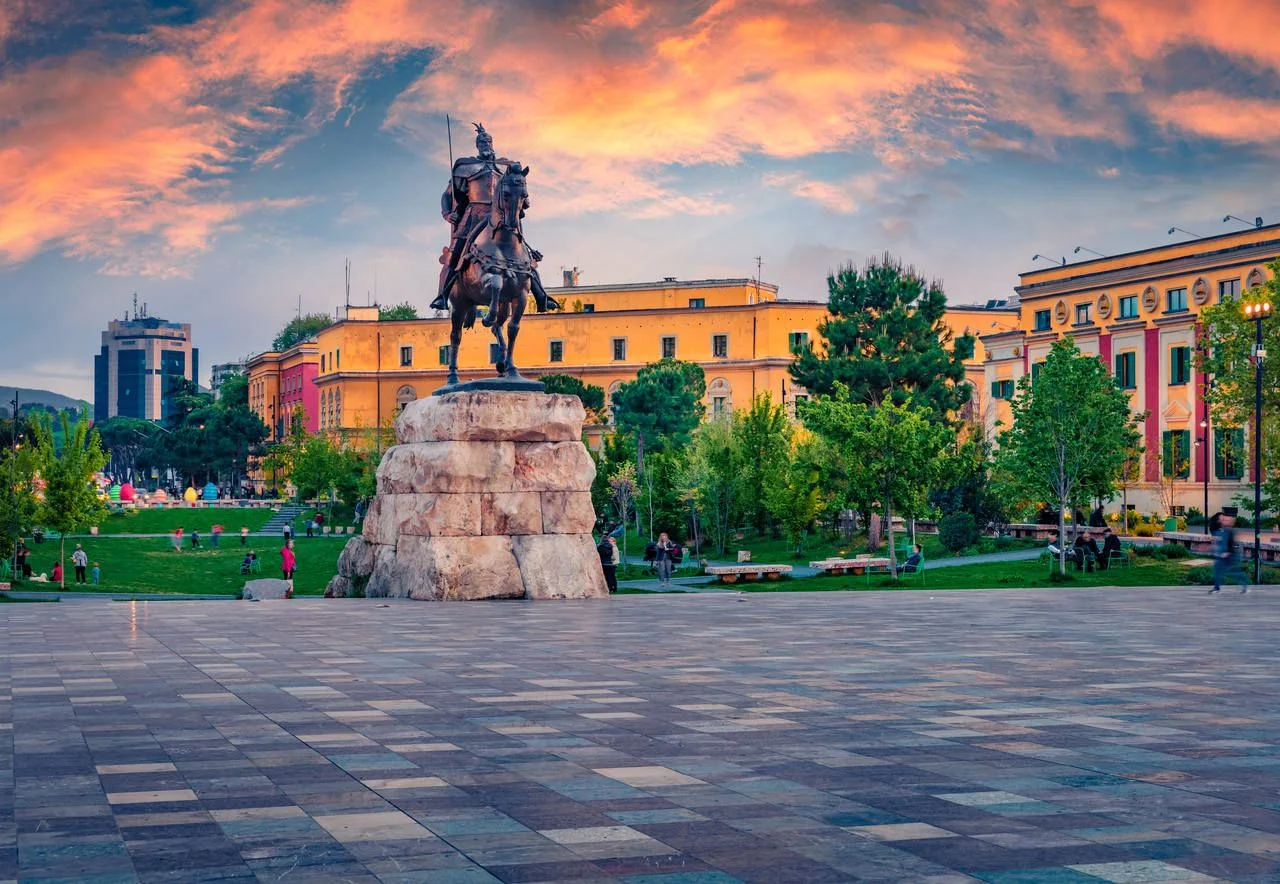 Splendid spring view of monument of Skanderbeg in Scanderbeg Square. Picturesque sunset in capital of Albania – Tirana. Traveling concept background.