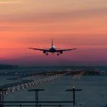a passenger plane lands on the airport runway early in the morning at sunrise in the freezing winter air