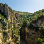 aerial picture of Osumi river canyon in the town of Skrapar in Albania shows the huge wide canyons and the river floating in between the cliffs. this is one of the best places to experience nature