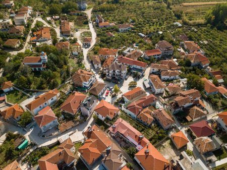 aerial picture taken with a drone of the small village of Tushemisht on Pogradec, east of Albania. on the photo you can see the village from above and the houses with orange rooftops