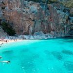 Cala Gonone, Sardinia, Italy, Cala Mariolu – Beautiful beach full of umbrellas and people sunbathing and swimming on a turquoise water