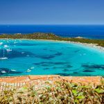 Clear see water, yachts and boats on Capo Coda Cavallo Beach (Tail of the horse), San Teodoro, Sardinia Island, Italy