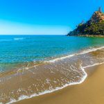 Golden shore and blue sea in Colostrai beach. Sardinia, Italy