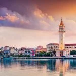 Impressive spring sunset in Zakynthos Town. Dramatic evening view of the City Hall and Saint Dioniysios Church, Ionian Sea, Zakynthos Island, Greece, Europe. Travel concept background.