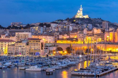 Marseille, France by night. View of the famous European port on Notre Dame de la Garde
