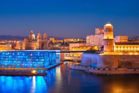 Marseille Old Port and Fort Saint-Jean and Museum of European and Mediterranean Civilisations and Marseille Cathedral illumintaed in night. Marseille, France. Marseille, France. Horizontal camera pan