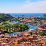 Panoramic view of the town of Bosa by the Temo river with Bosa Marina resort at the Mediterranean sea coast seen from Malaspina Castle hill – Sardinia, Italy
