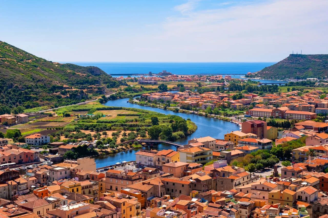 Panoramic view of the town of Bosa by the Temo river with Bosa Marina resort at the Mediterranean sea coast seen from Malaspina Castle hill – Sardinia, Italy