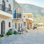 Street in Plaka village with mountain in the background, Crete island, Greece.