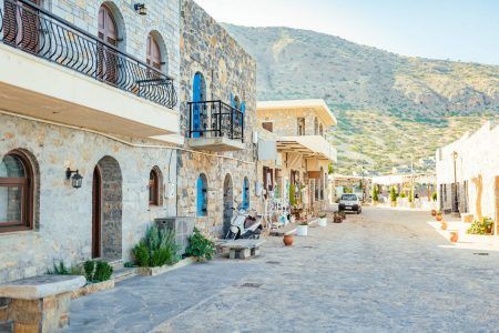 Street in Plaka village with mountain in the background, Crete island, Greece.