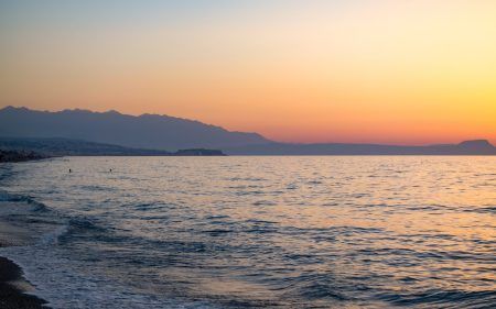 Sunset in the beach of Aegeian sea in Adelianos Kampos resort, Crete island, Greece