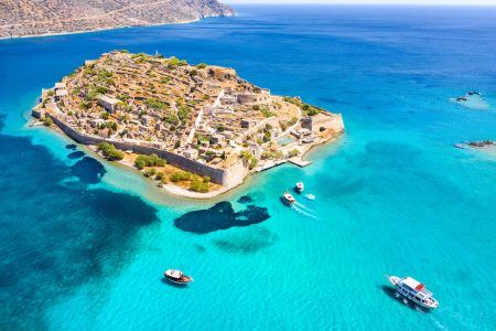 View of the island of Spinalonga with calm sea. Here were isolated lepers, humans with the Hansen’s desease, gulf of Elounda, Crete, Greece.