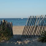 View on white sandy beach Les Sablettes in La Seyne-sur-mer in morning sunlights