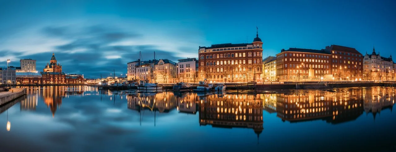 Helsinki, Finland. Panoramic view of Kanavaranta Street with Uspensky Cathedral and Pohjoisranta Street in the evening night illuminations.