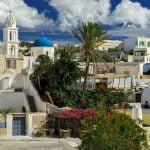 SANTORINI (THERA), CYCLADES, GREECE – South view of traditional village Megalochori with its old style Greek mansions.