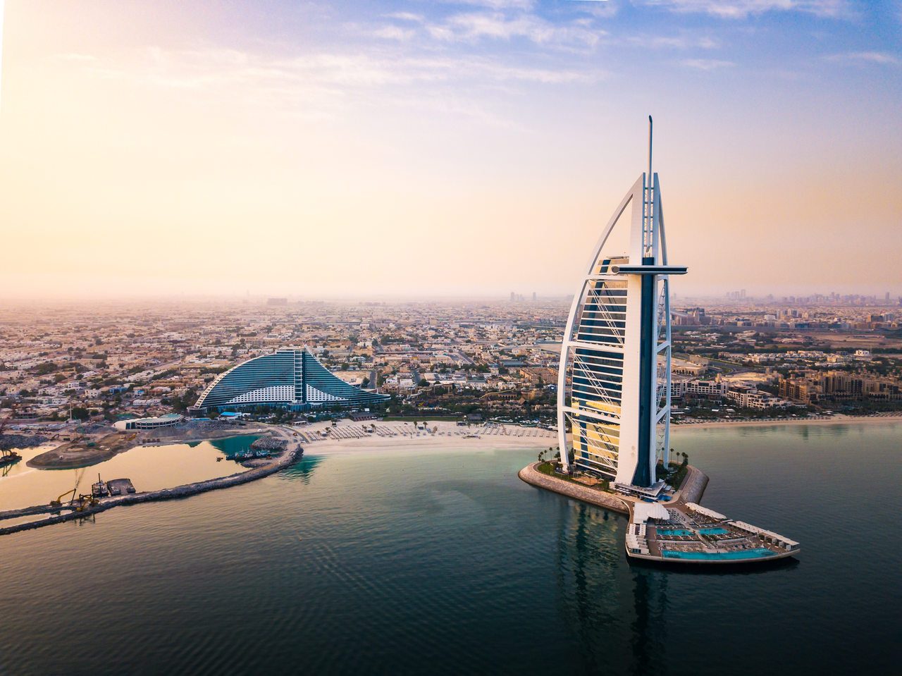 seaside skyline and Burj Al Arab luxury hotel aerial view at sunrise