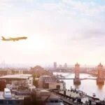 travel to london by plane in the sky over tower bridge