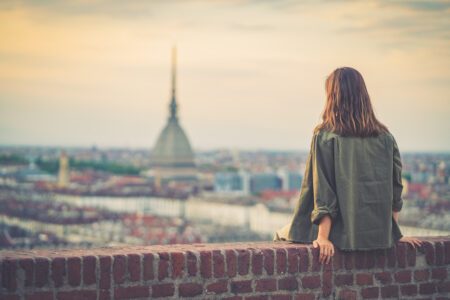 Girl explore Piemonte, Italy. Town and mountain. Cityscape, old historic architecture. Travel, adventure, lifestyle