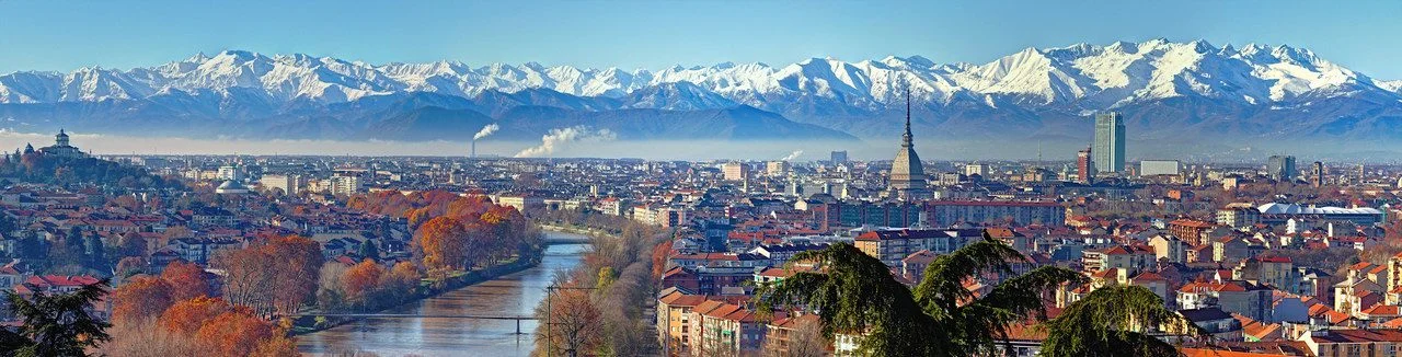 Panoramic view on Turin skyline, with the city center, Po river and Mole Antonelliana, in a clear winter morning with snowy alps on background