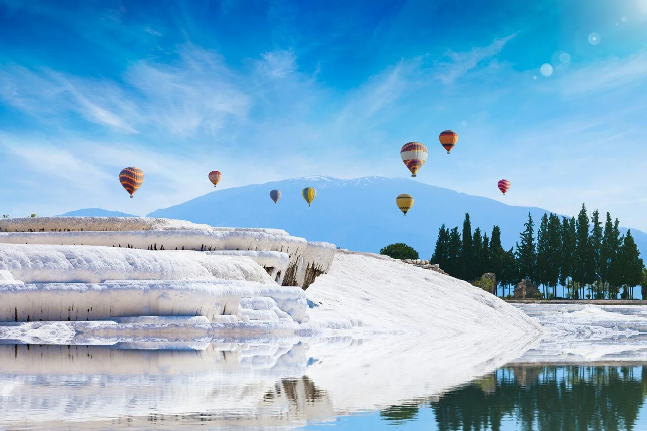 Amazing white travertine terrace formations, pool with clear hot water from thermal springs in Pamukkale