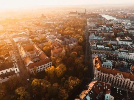 Sunrise view on Krakow main square and streets. Cracow, Lesser Poland province. St. Mary’s Basilica, Rynek Glowny, Wawel castle
