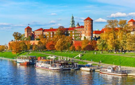 Wawel castle famous landmark in Krakow Poland. Picturesque landscape on coast river Wisla. Autumn sunset with white sky and cloud.