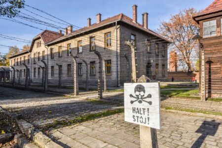 wooden sign with a picture of a skull in Auschwitz concentration camp